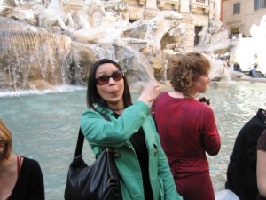 Tossing a coin into the Trevi fountain because I'll want to come back to Rome someday!
